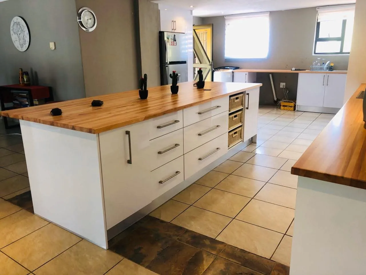 Timber tops kitchen — Warmth against a painted run